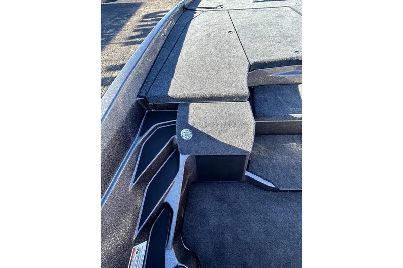 Slide: The Image of 2026 Skeeter ZXE21 boat deck with carpeted surface and storage compartments. - 23