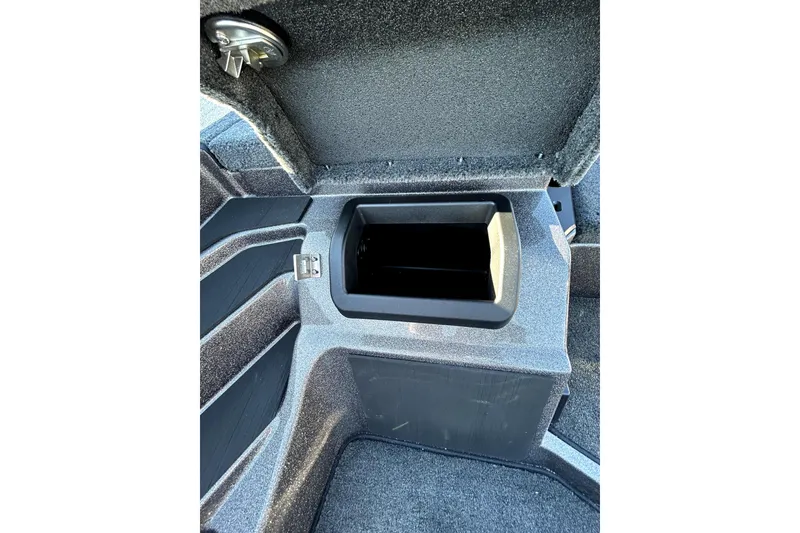 Slide: The Image of 2026 Skeeter ZXE21 boat storage compartment with open lid, showcasing interior space. - 24