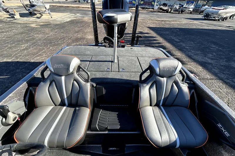Slide: The Image of 2026 Skeeter ZXE21 boat interior with dual seats and steering wheel. - 25