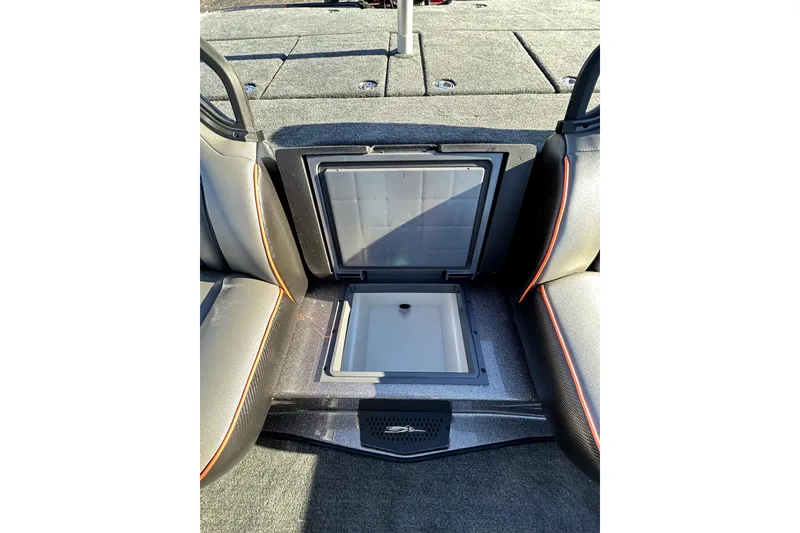 Slide: The Image of 2026 Skeeter ZXE21 boat interior with open storage compartment, gray seating, and orange accents. - 27