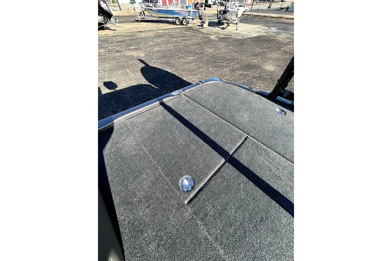 Slide: The Image of 2026 Skeeter ZXE21 boat deck with carpeted surface and storage compartments. - 29