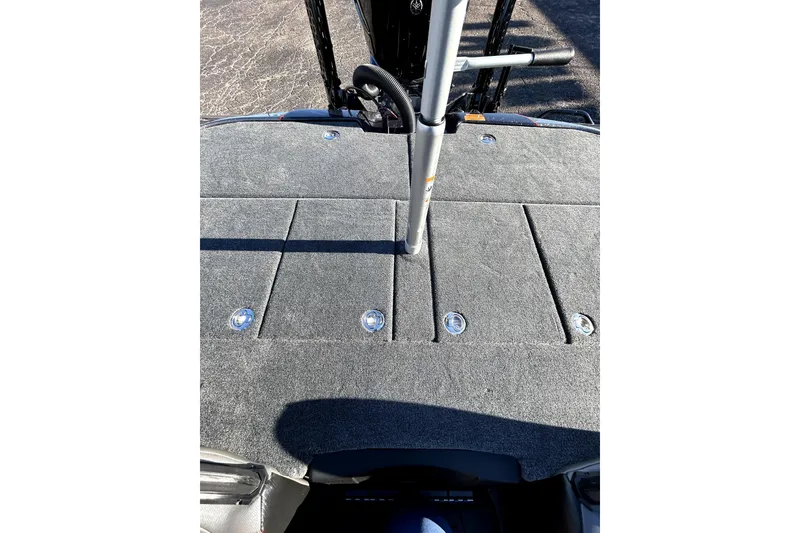 Slide: The Image of 2026 Skeeter ZXE21 boat deck with gray carpet and storage compartments. - 31