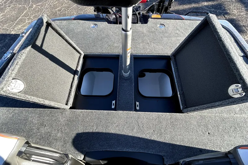 Slide: The Image of 2026 Skeeter ZXE21 boat storage compartments with open lids, showcasing interior space. - 32