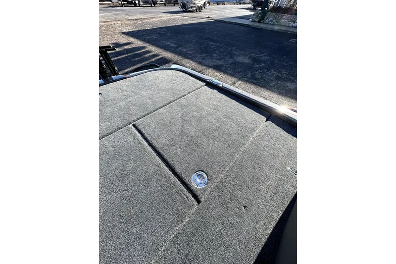 Slide: The Image of 2026 Skeeter ZXE21 boat deck with carpeted surface and latch detail. - 33