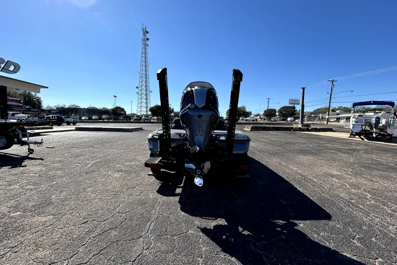 Slide: The Image of 2026 Skeeter ZXE21 boat parked in a sunny lot, rear view. - 5