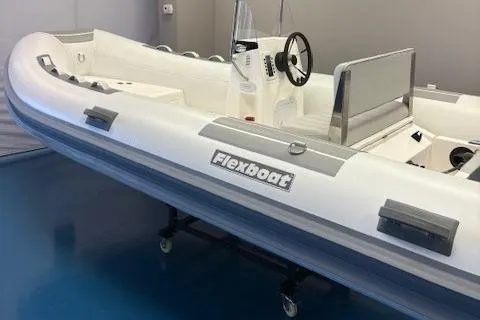 Slide: The Image of 2023 Flexboat SR15 inflatable boat with steering console, displayed indoors. - 3
