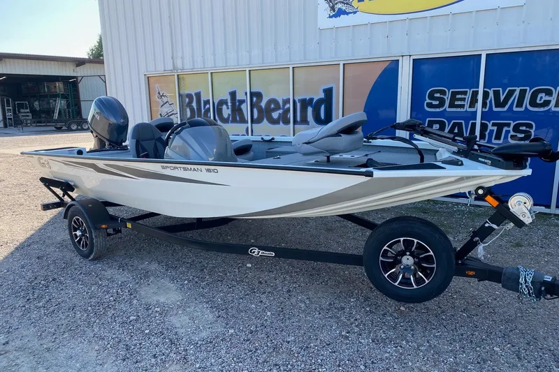 Slide: The Image of 2026 G3 Sportsman 1610 boat on trailer, parked outside BlackBeard service center. - 2