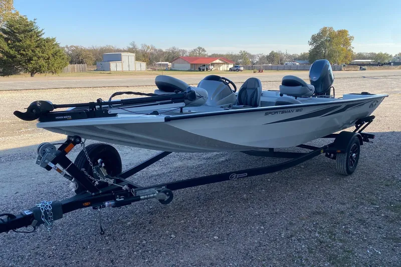 Slide: The Image of 2026 G3 Sportsman 1610 boat on trailer, parked outdoors, featuring Minn Kota motor. - 3