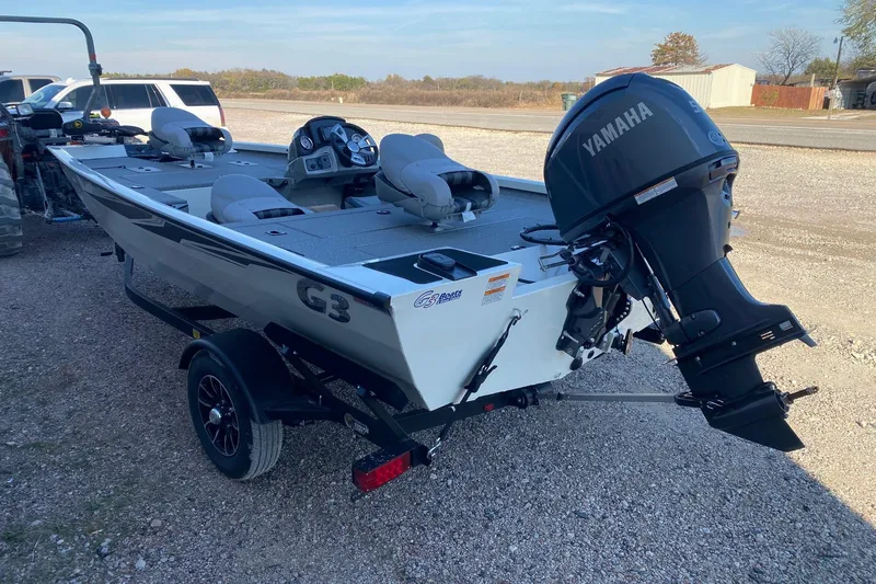 Slide: The Image of 2026 G3 Sportsman 1610 boat with Yamaha motor on trailer, parked outdoors. - 4