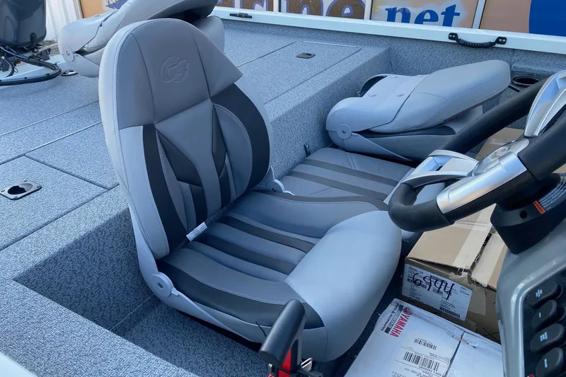 Slide: The Image of 2026 G3 Sportsman 1610 boat interior with gray seating and steering wheel. - 8