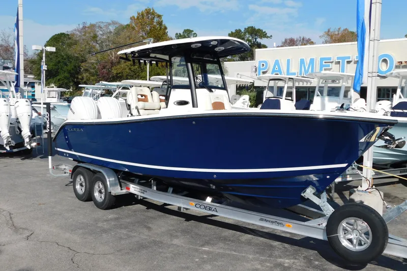 The Image of 2026 Cobia 265 Center Console boat on trailer at dealership. - 0