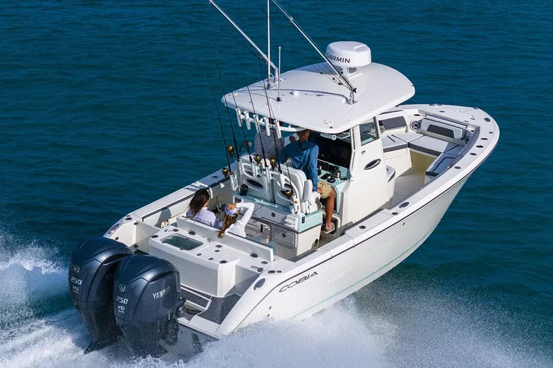 Slide: The Image of 2026 Cobia 265 Center Console boat interior with rod holders and storage compartments. - 10