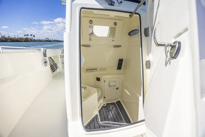 Slide: The Image of 2026 Cobia 265 Center Console boat with open storage compartments and livewell. - 17
