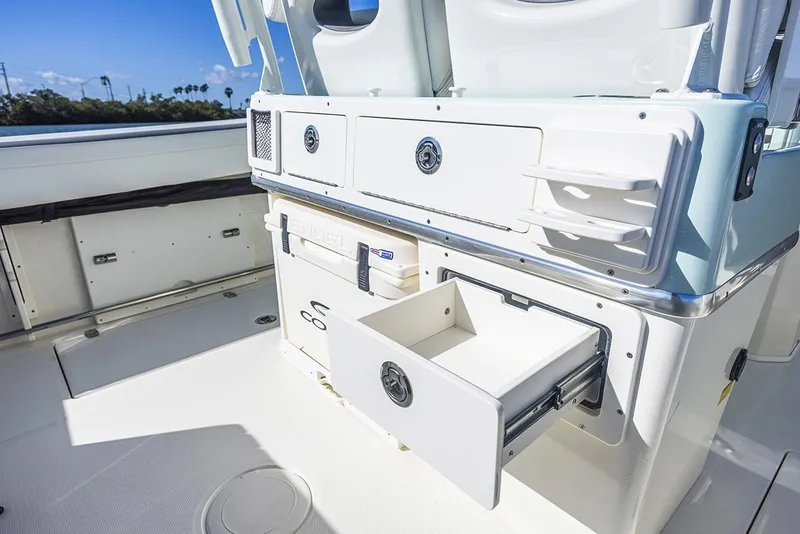 Slide: The Image of 2026 Cobia 265 Center Console boat interior with cushioned seating and Yamaha engines. - 21