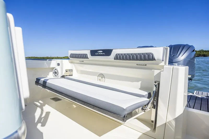 Slide: The Image of 2026 Cobia 265 Center Console boat with dual engines and storage compartments. - 23