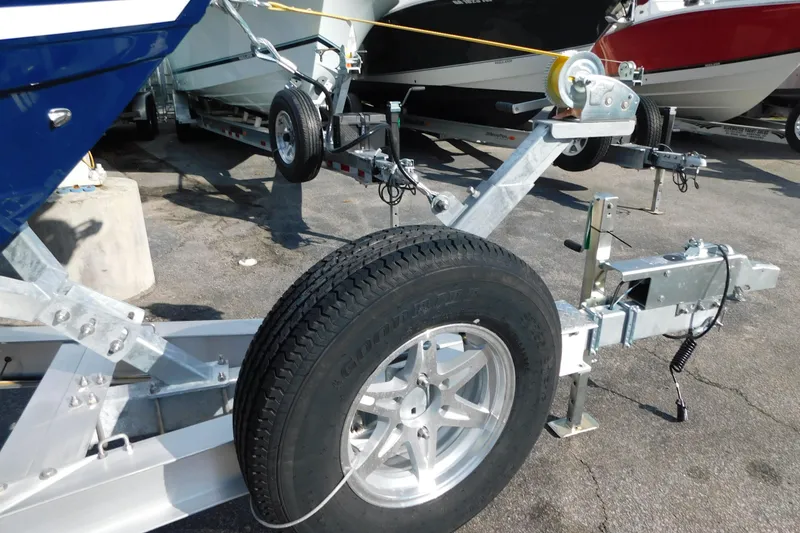 Slide: The Image of 2026 Cobia 265 Center Console boat's blue T-top with rod holders and speakers. - 26