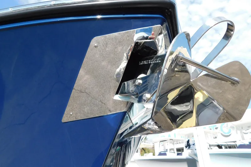 Slide: The Image of Close-up of a 2026 Cobia 265 Center Console boat's chrome hardware on a blue surface. - 27