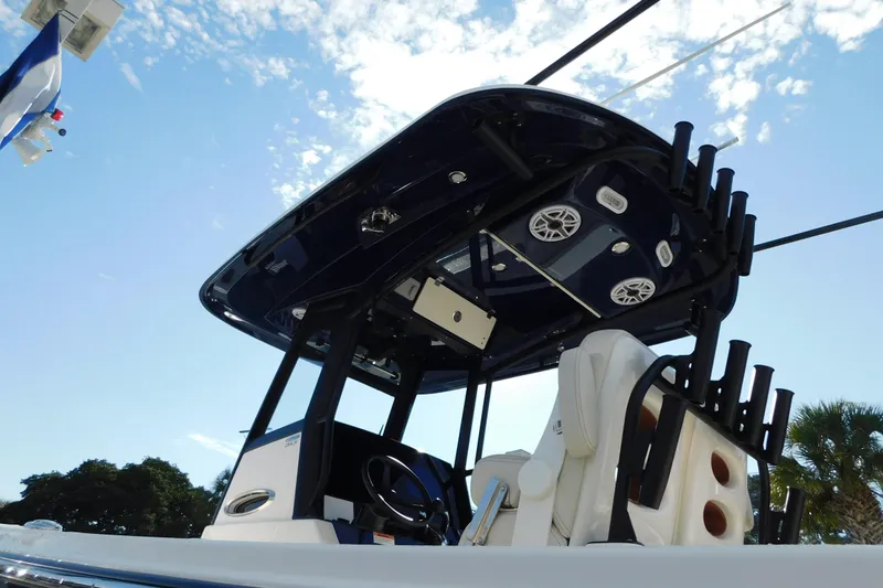 Slide: The Image of 2026 Cobia 265 Center Console boat dashboard with steering wheel and electronic displays. - 3