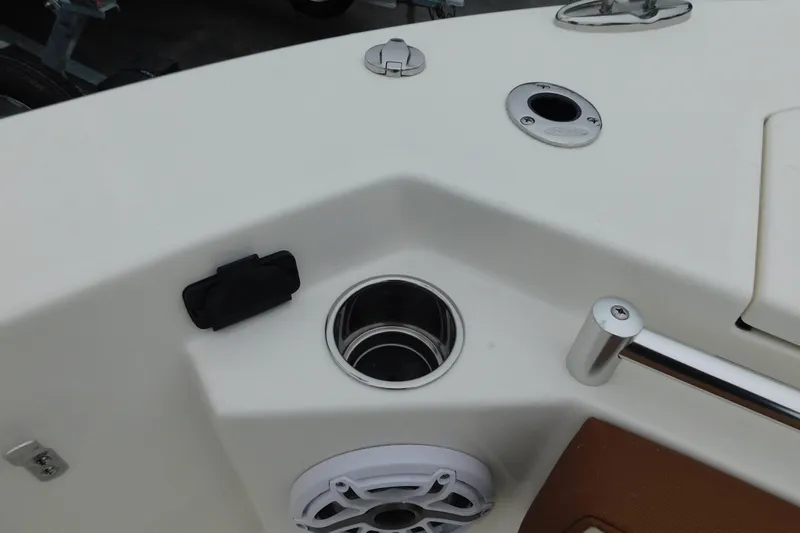 Slide: The Image of 2026 Cobia 265 Center Console boat interior with cup holder and speaker. - 33