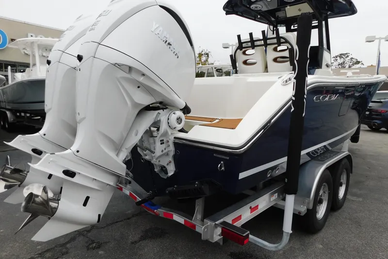 Slide: The Image of 2026 Cobia 265 Center Console boat with dual Yamaha outboard engines on a trailer. - 44