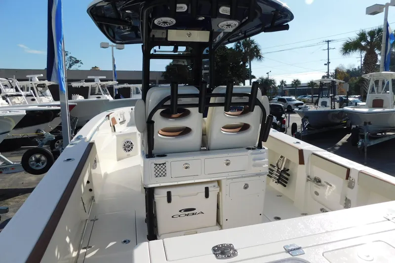 Slide: The Image of 2026 Cobia 265 Center Console boat controls with JL Audio system and wireless charging pad. - 5