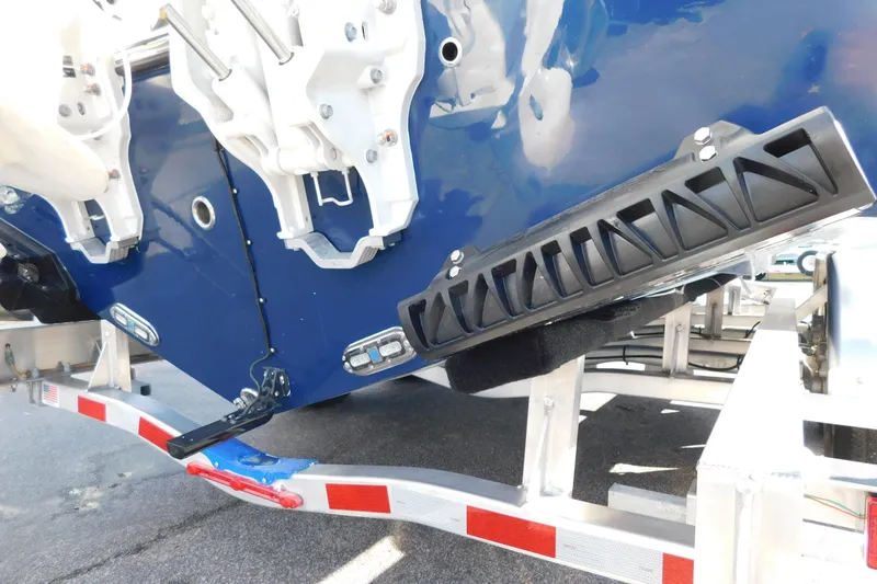 Slide: The Image of 2026 Cobia 265 Center Console boat interior with Garmin equipment and storage compartment. - 6