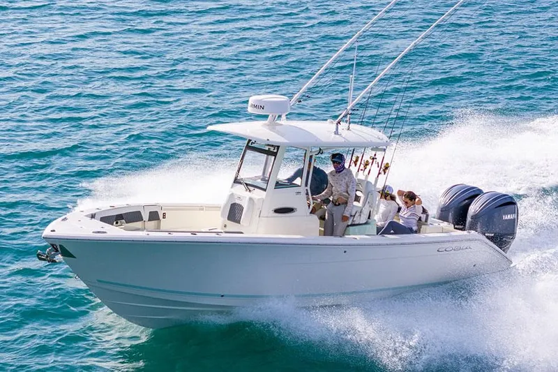 Slide: The Image of 2026 Cobia 265 Center Console boat interior with seating and storage, displayed outdoors. - 9