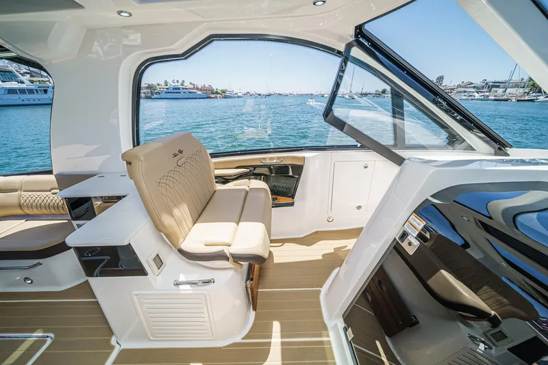 Slide: The Image of 2023 Sea Ray Sundancer 370 OB interior with luxurious seating and ocean view. - 20