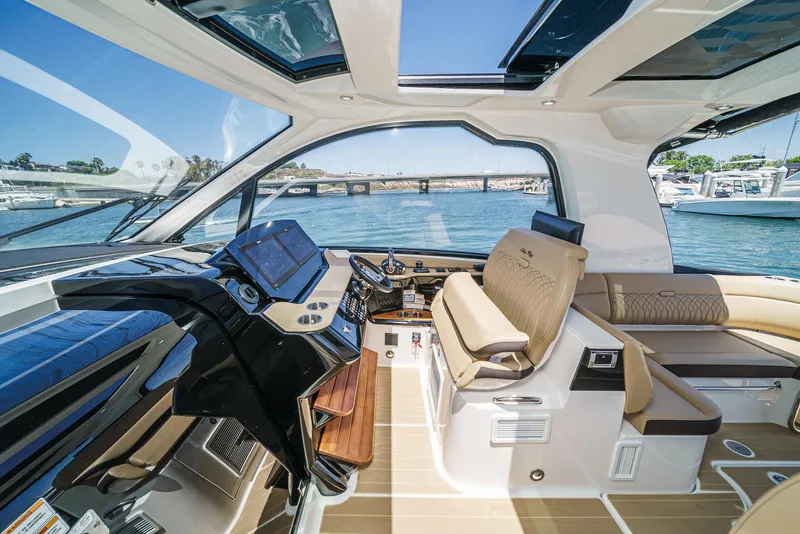 Slide: The Image of 2023 Sea Ray Sundancer 370 OB cockpit with luxurious seating and advanced navigation systems. - 21