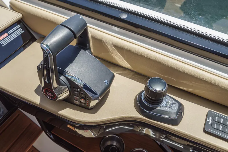 Slide: The Image of Control panel of 2023 Sea Ray Sundancer 370 OB boat, featuring throttle and joystick. - 24