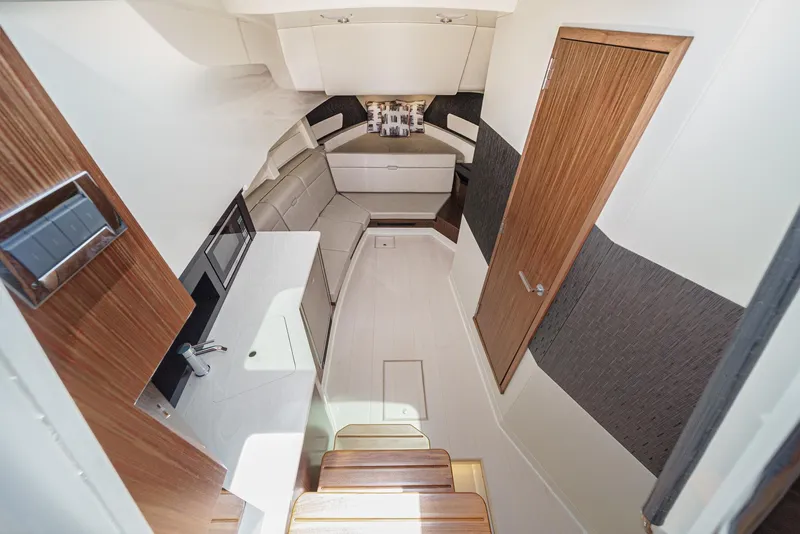 Slide: The Image of 2023 Sea Ray Sundancer 370 OB interior with modern design and wood accents. - 26