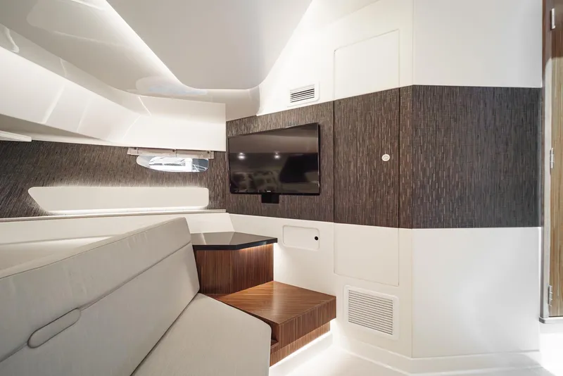 Slide: The Image of Interior of 2023 Sea Ray Sundancer 370 OB, featuring modern seating and a wall-mounted TV. - 30