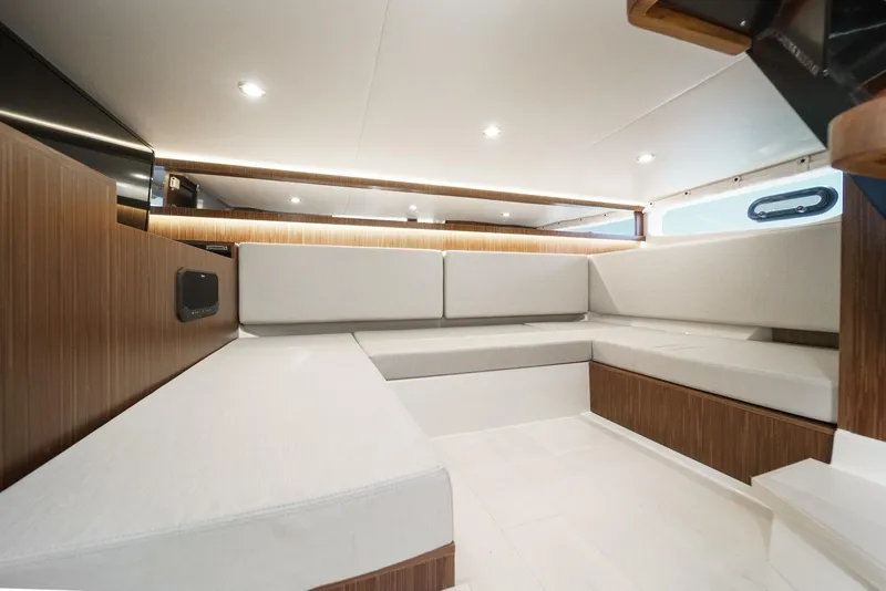 Slide: The Image of Interior of 2023 Sea Ray Sundancer 370 OB, featuring modern seating and wood accents. - 35