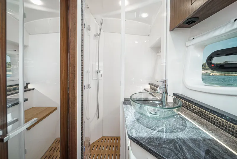Slide: The Image of Luxurious bathroom in 2023 Sea Ray Sundancer 370 OB yacht with glass sink and shower. - 36