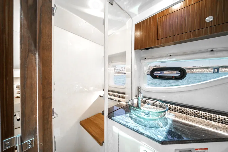 Slide: The Image of 2023 Sea Ray Sundancer 370 OB interior with modern sink and window view. - 37