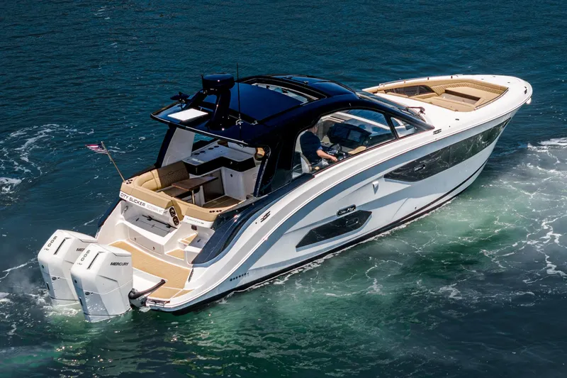 Slide: The Image of 2023 Sea Ray Sundancer 370 OB cruising on clear blue water. - 4