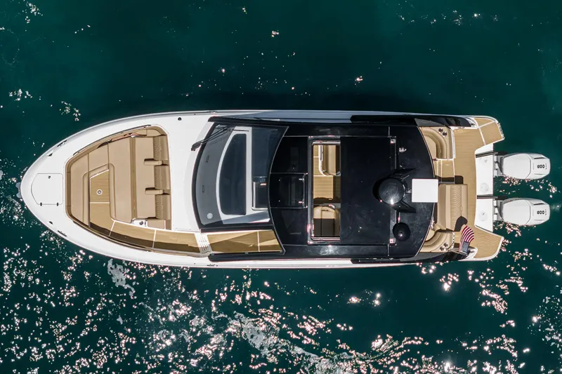 Slide: The Image of 2023 Sea Ray Sundancer 370 OB yacht, aerial view, cruising on clear blue water. - 6