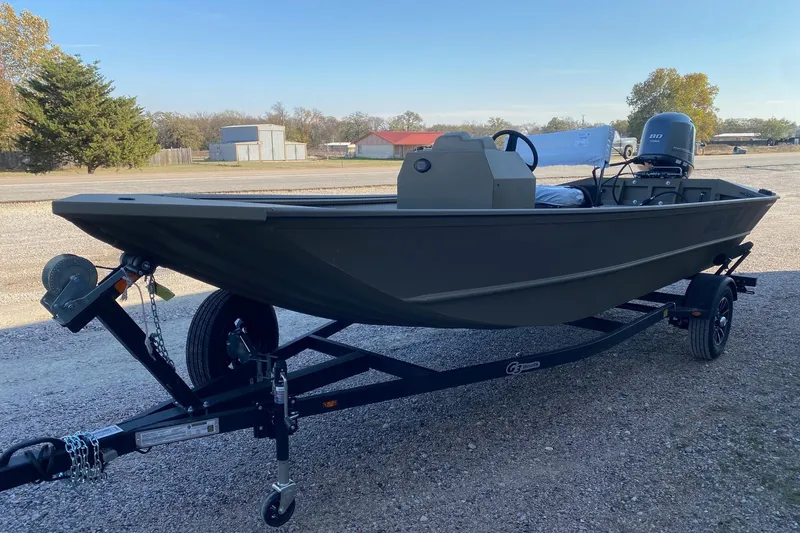 Slide: The Image of 2026 G3 Gator Tough 18 CCJ boat on trailer, parked outdoors. - 3