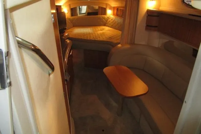Slide: The Image of 2006 Sea Ray 300 Sundancer cabin interior with cozy seating and bed. - 11