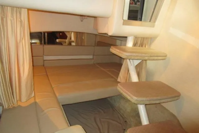 Slide: The Image of Interior cabin of 2006 Sea Ray 300 Sundancer with beige seating and steps. - 18