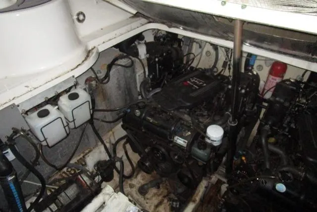 Slide: The Image of Engine compartment of a 2006 Sea Ray 300 Sundancer boat, showing mechanical components. - 25