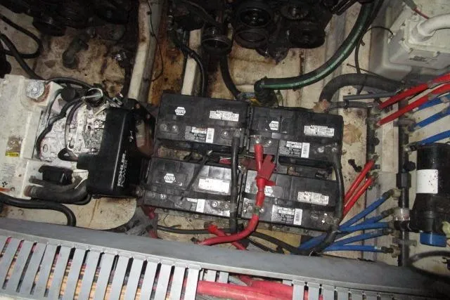 Slide: The Image of Engine compartment of 2006 Sea Ray 300 Sundancer with multiple batteries and wiring. - 26