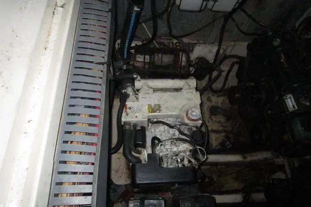 Slide: The Image of Engine compartment of 2006 Sea Ray 300 Sundancer, showing mechanical components and wiring. - 27
