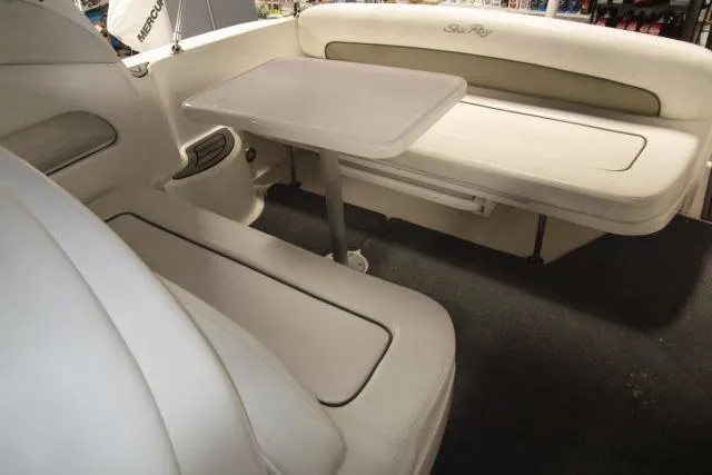 Slide: The Image of Interior seating area of 2006 Sea Ray 300 Sundancer boat with table. - 8