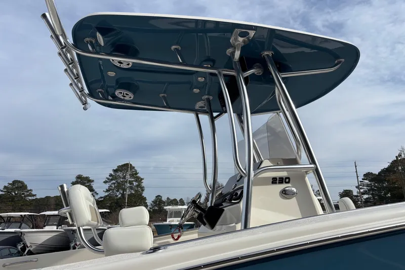 Slide: The Image of 2026 Bulls Bay 230 Center Console boat with T-top and seating, under a clear sky. - 4