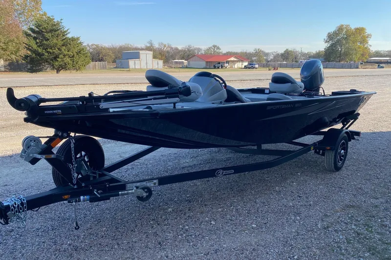 Slide: The Image of 2026 G3 Sportsman 1610 boat on trailer, parked outdoors on gravel. - 3