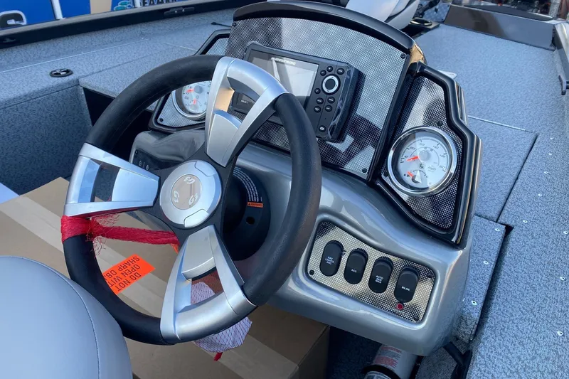 Slide: The Image of 2026 G3 Sportsman 1610 boat dashboard with steering wheel and gauges. - 7