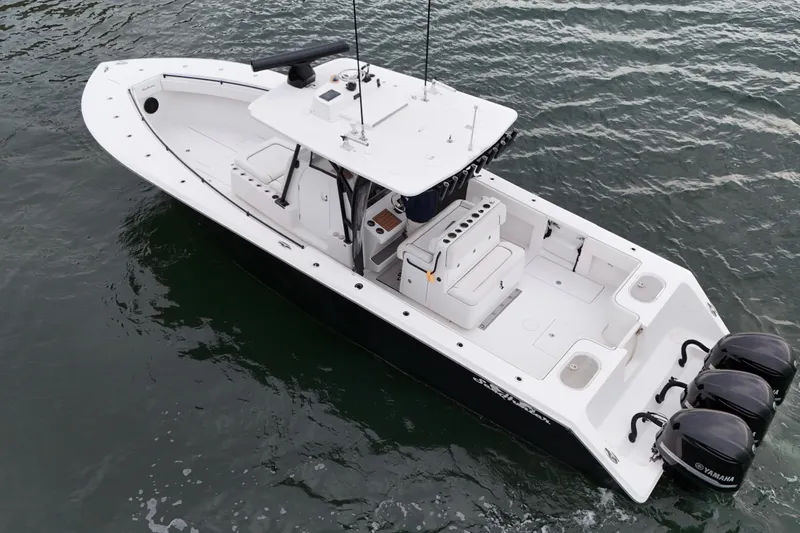 Slide: The Image of 2016 Sea Hunter 35 Tournament boat with triple Yamaha engines on water. - 10