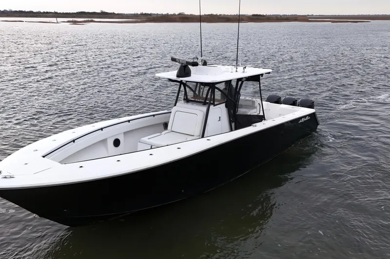 Slide: The Image of 2016 Sea Hunter 35 Tournament boat on calm water, featuring sleek black and white design. - 11