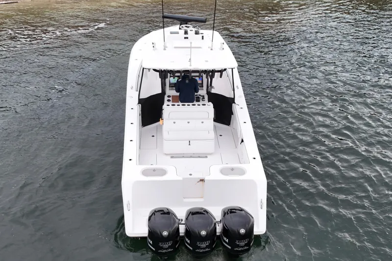 Slide: The Image of 2016 Sea Hunter 35 Tournament boat with triple outboard engines on water. - 12